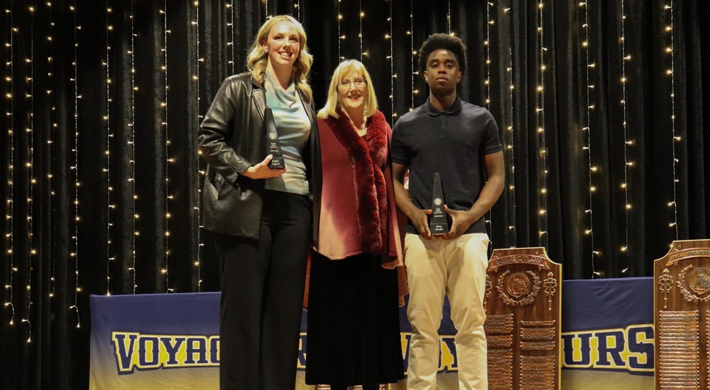 Emilie Lafond and Brice Fandio receiving their Athlete of the Year awards from Laurentian president, Dr. Lynn Wells - Tyra Swan